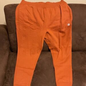 (Champion) joggers. Burnt orange color and X-Large in size.